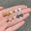 Fashionable black smiley face earrings, feminine style, Korean simple and cool style, asymmetrical crying smiley face ear bone nail ins