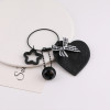 Creative new black leather love hollow star bow keychain bag pendant jewelry accessories